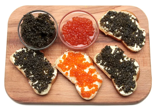 Caviar negro y rojo en recipiente de vidrio — Foto de Stock