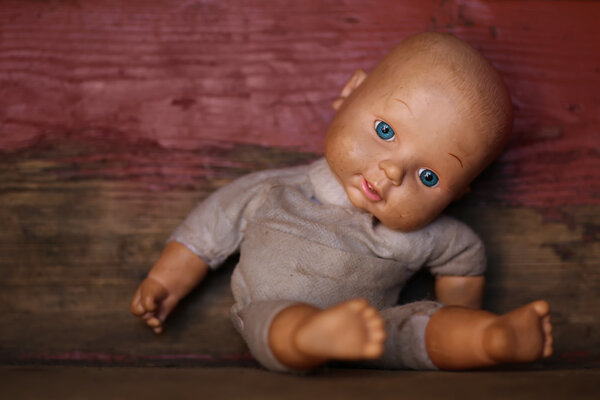 Old Doll. Concept: Abandoned Person. Close up an old broken doll .