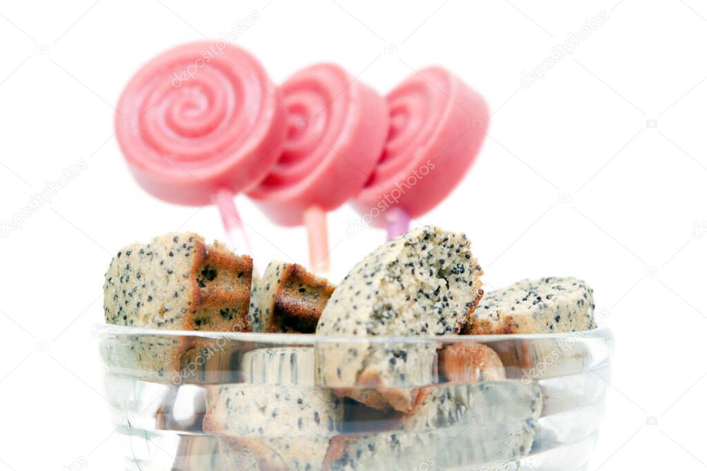 Muffins with poppy & popsicles isolated on a white background