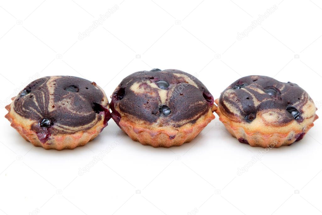 Muffins with berries isolated on white background