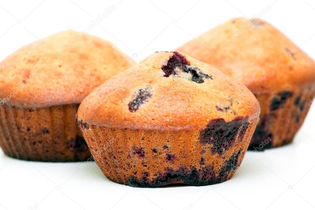 Muffins with berries isolated on a white background