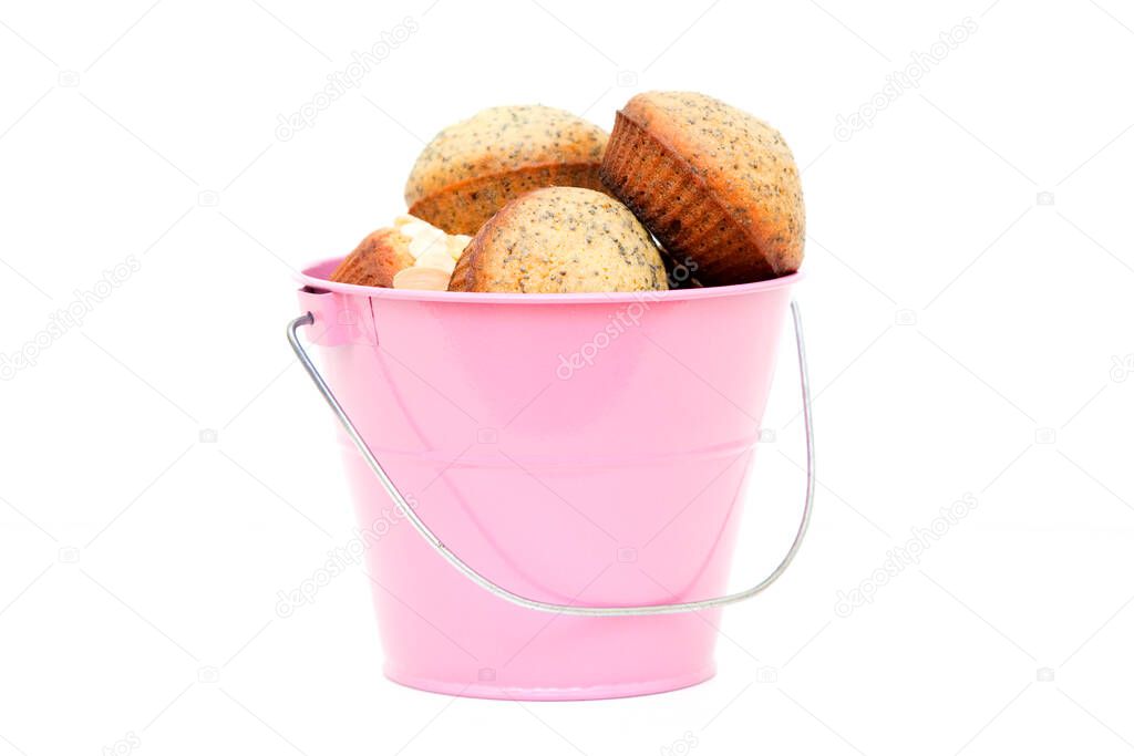 Muffins in a bucket isolated on a white background