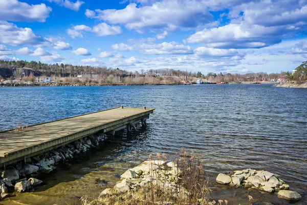 Wooden bridge on spring Swedish coast — Stock Photo, Image