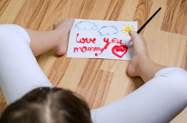 School girl painting with foot — Stock Photo, Image