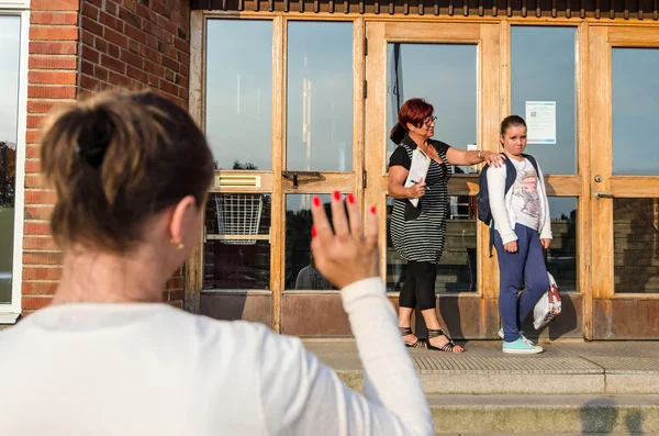 Waving goodbye to upset schoolgirl — Stock Photo, Image