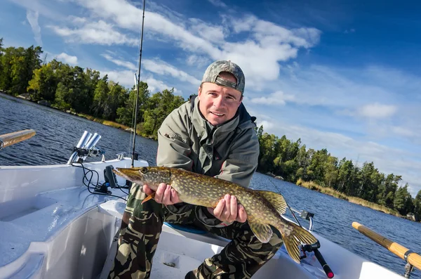 Man with autumn lake pike — Stock Photo, Image