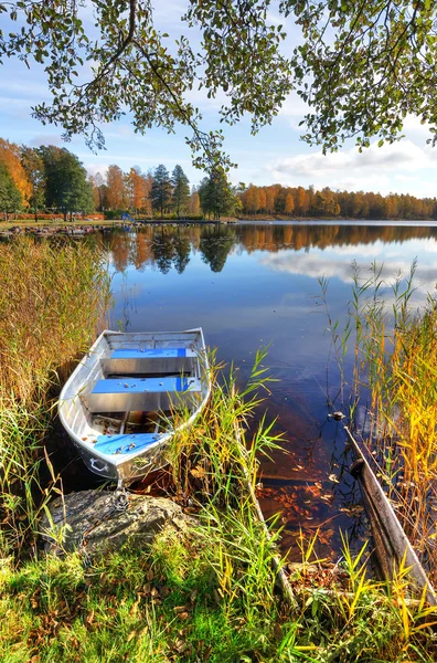 Vertical autumn landscape with aluminium boat — Stock Photo, Image