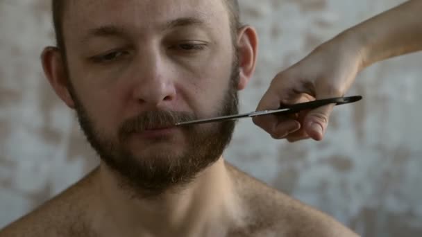 Mujer cortando el bigote del hombre — Vídeos de Stock