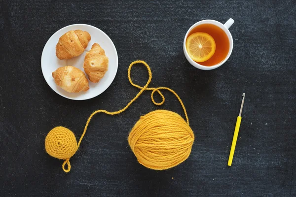 Lemon tea, yellow crocheting and croissants — Stock Photo, Image