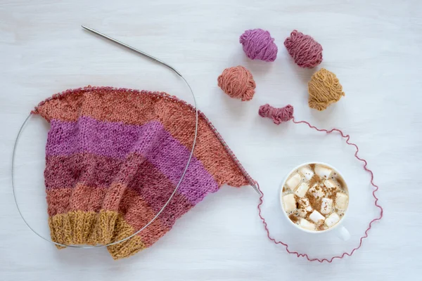 Cup of coffee and knitting on white background — Stock Photo, Image