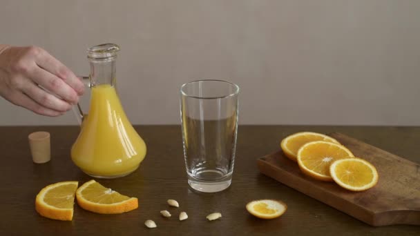 Pouring orange juice into a glass — Stock Video