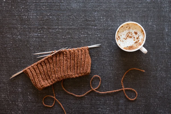 Coffee and knitting on black background — Stock Photo, Image