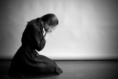 Crying woman sitting on the floor