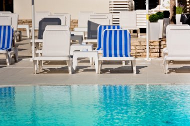 Otel havuz sandalyeleri yakınındaki bir Yüzme Havuzu