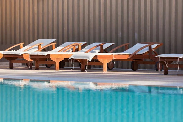 Hotel Poolside Chairs near a swimming pool — Stock Photo, Image