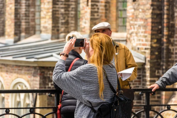 La donna sta facendo delle foto per la strada di Bruges. — Foto Stock