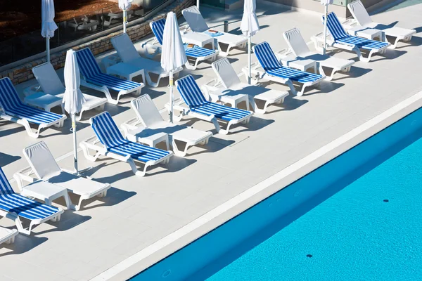 Hotel Poolside Chairs near a swimming pool — Stock Photo, Image