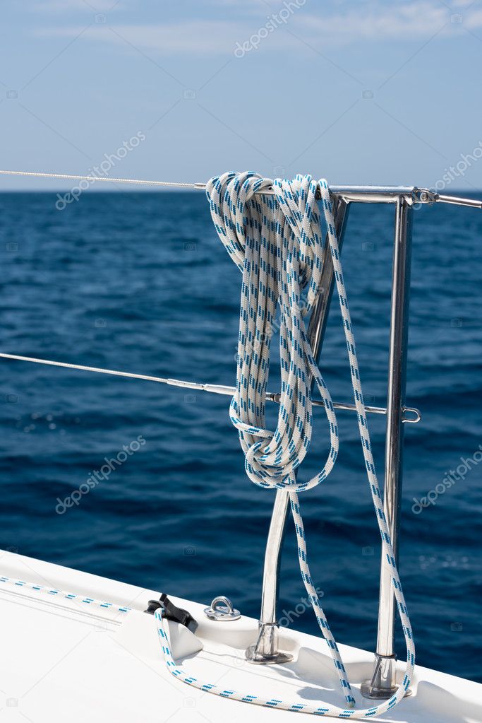A rope tied around a lifeline on a yacht
