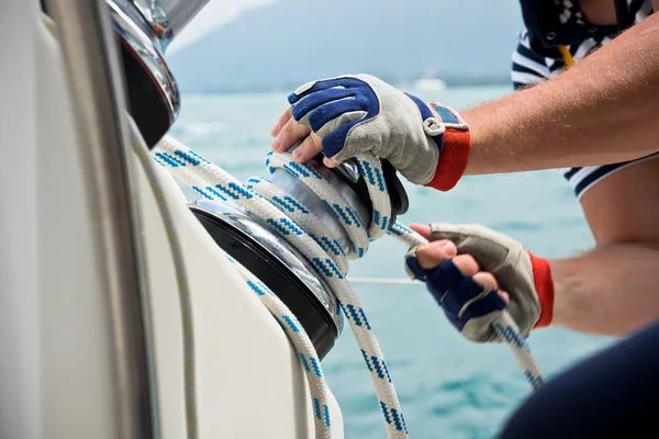 Winch and sailors hands — Stock Photo, Image