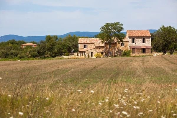 Steinhaus in einem abgeernteten Feld — Stockfoto