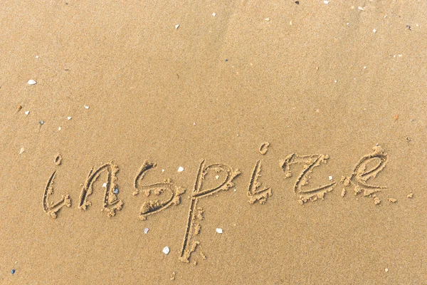 Inspira escrito en la arena de la playa — Foto de Stock