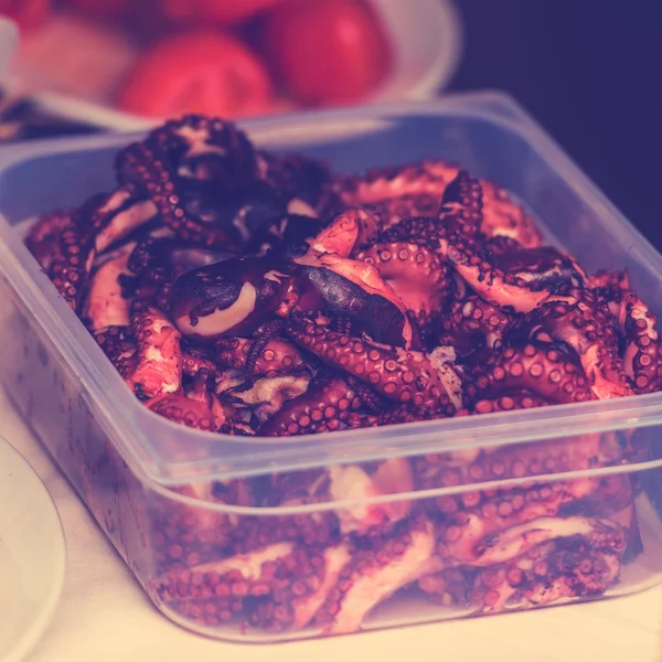 Cooked octopus parts in a box — Stock Photo, Image