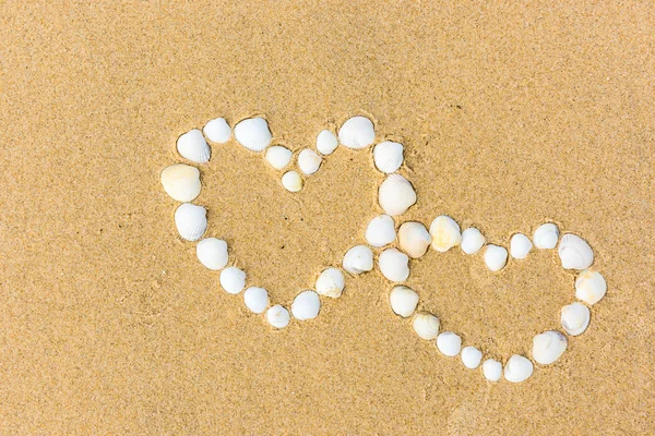 Sea shell hearts on the beach — Stock Photo, Image