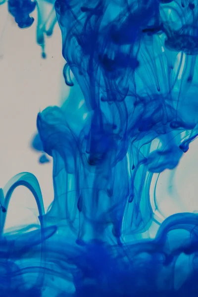 Blue liquid in water making abstract forms — Stock Photo, Image