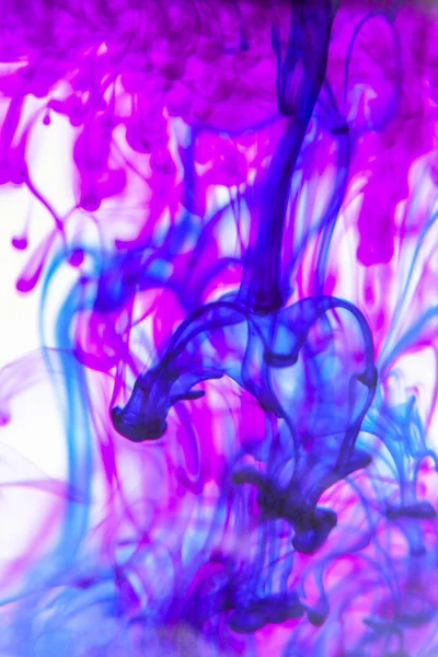 Blue and violet liquid in water making abstract forms — Stock Photo, Image