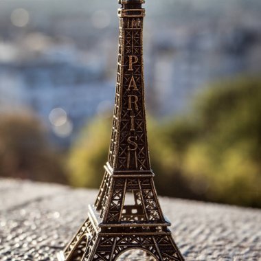 PARIS, FRANCE, 1 Ekim 2016. Montmartre 'da. Eyfel araştırma platformundan şehrin gündoğumu görüntüsünün arka planında hatıra oyuncağı taşıyor