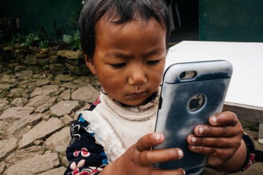 HIMALAYAS, Everest REGION, NEPAL - 20 EKİM 2018: Evinin yakınındaki Himalaya köyündeki sokakta Nepal kızı portresi