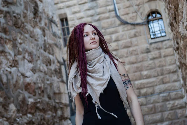 Portrait of a  young woman with pink dreadlocks in Old Jerusalem