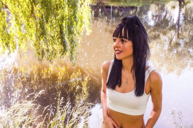 Güneşin doğuşunda gölün yanında güzel genç bir kadın