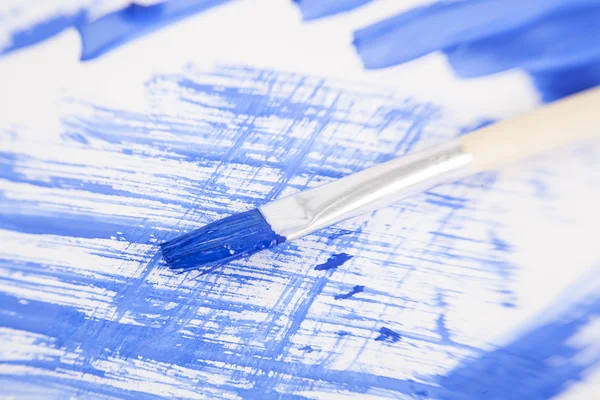 Blue painted background with brush — Stock Photo, Image