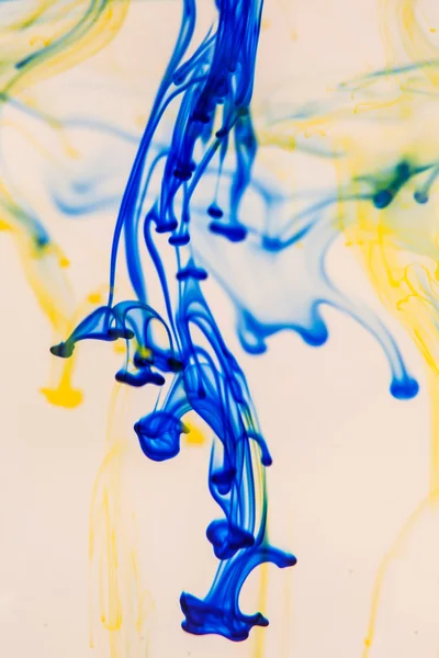 Blue and yellow liquid in water