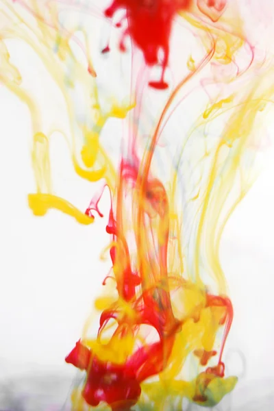 Red and yellow liquid in water — Stock Photo, Image