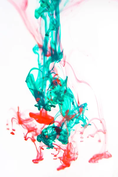 Red and green liquid in water — Stock Photo, Image