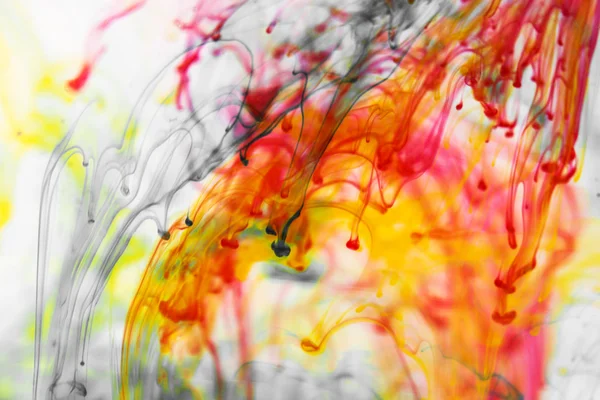 Red and yellow liquid in water — Stock Photo, Image