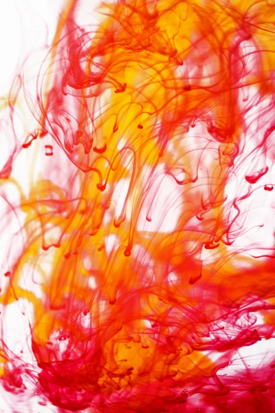 Red and yellow liquid in water — Stock Photo, Image