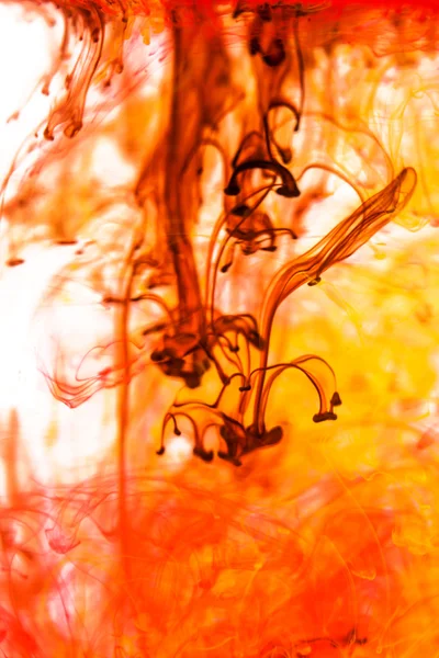 Red and yellow liquid in water — Stock Photo, Image