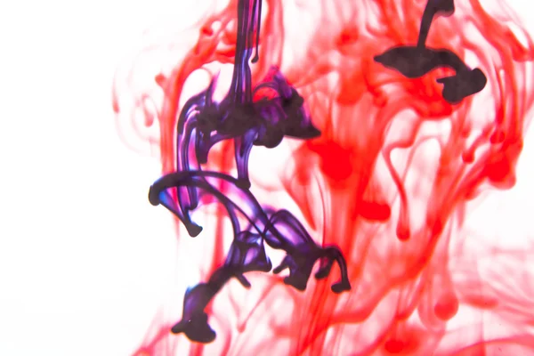 Red and violet  liquid in water — Stock Photo, Image
