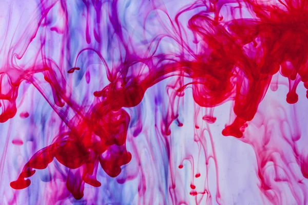 Red and violet liquid in water — Stock Photo, Image