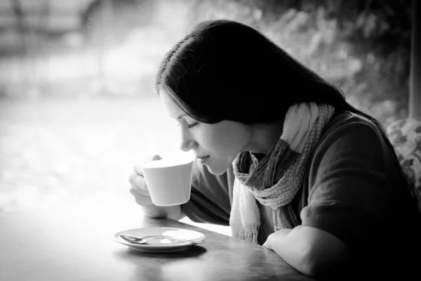 Beautiful young woman with a cup of tea at a cafe — Stock Photo, Image