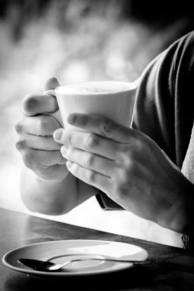 Woman hands with latte on a wood table — Stock Photo, Image