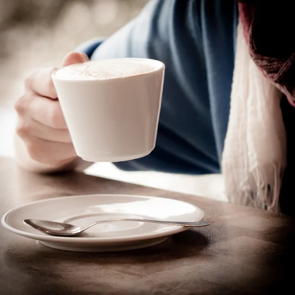 Woman hands with latte on a wood table — Stock Photo, Image