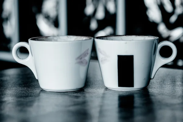 Two coffee cups with red hearts as a kissing lips — Stock Photo, Image