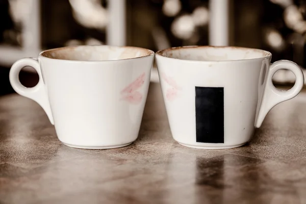 Two coffee cups with red hearts as a kissing lips — Stock Photo, Image