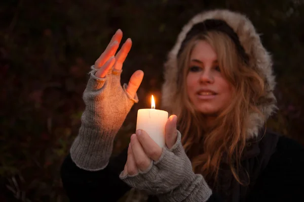 Young woman looking to a candle — Stock Photo, Image