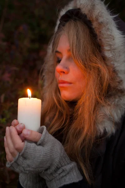 Νεαρή γυναίκα που ψάχνει για ένα κερί — Φωτογραφία Αρχείου