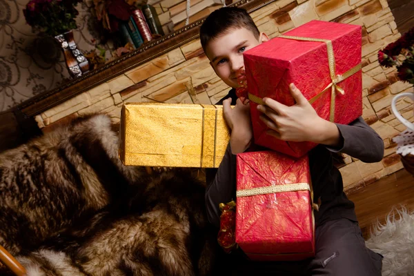 Portrait of adorable boy with giftboxes — Stock Photo, Image